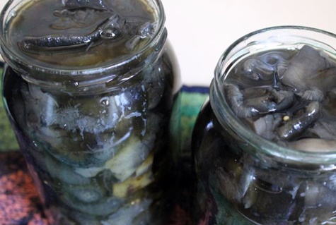 pickled mushrooms in jars on the table