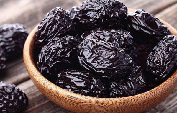 eine Vase mit Pflaumen